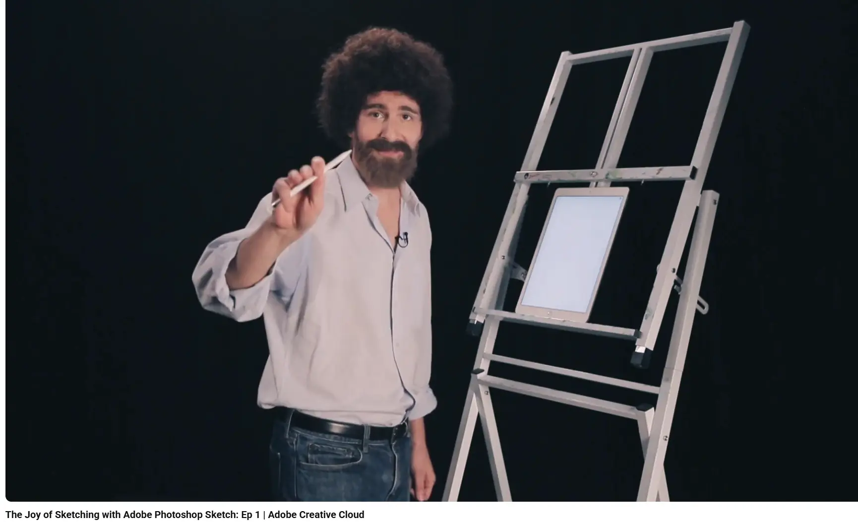 Screenshot from an Adobe video ad mimicking Bob Ross-styled painting with a sketchbook