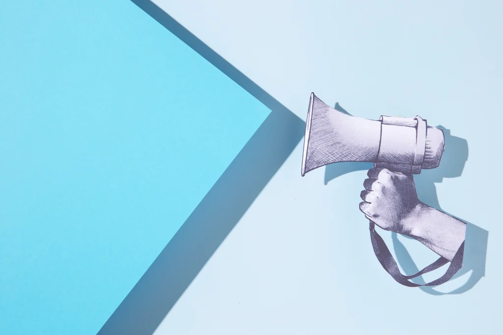 Graphic of paper microphone hel by hand